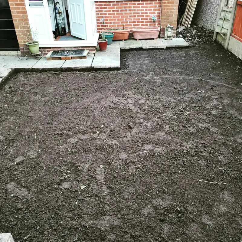 The same garden with the grass dug out and the ground levelled, ready for gravel