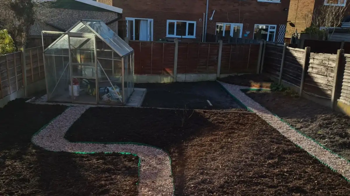 Finished back garden remodel by MM Contractors with a riven patio, gravel path and new beds