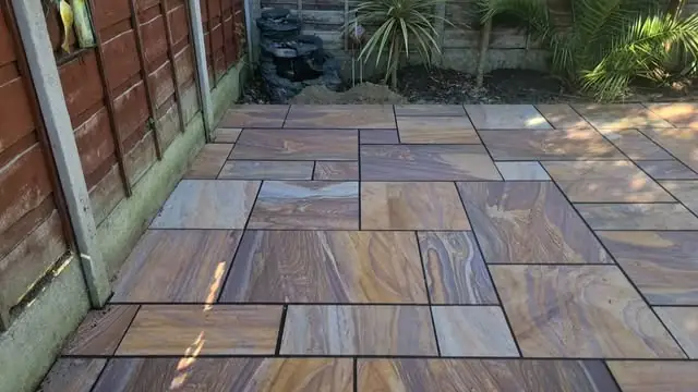 Rainbow Indian sandstone patio in warm browns and purples, finished with black jointing